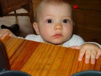 Luca peering over the table